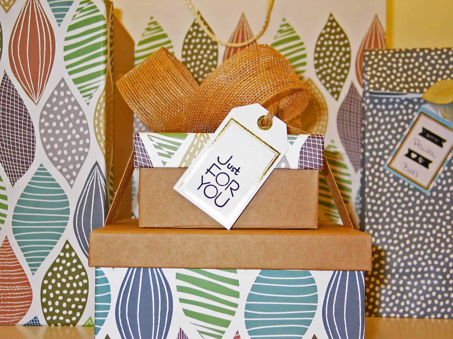 Stacked & neatly wrapped presents with a “For You” gift tag on them